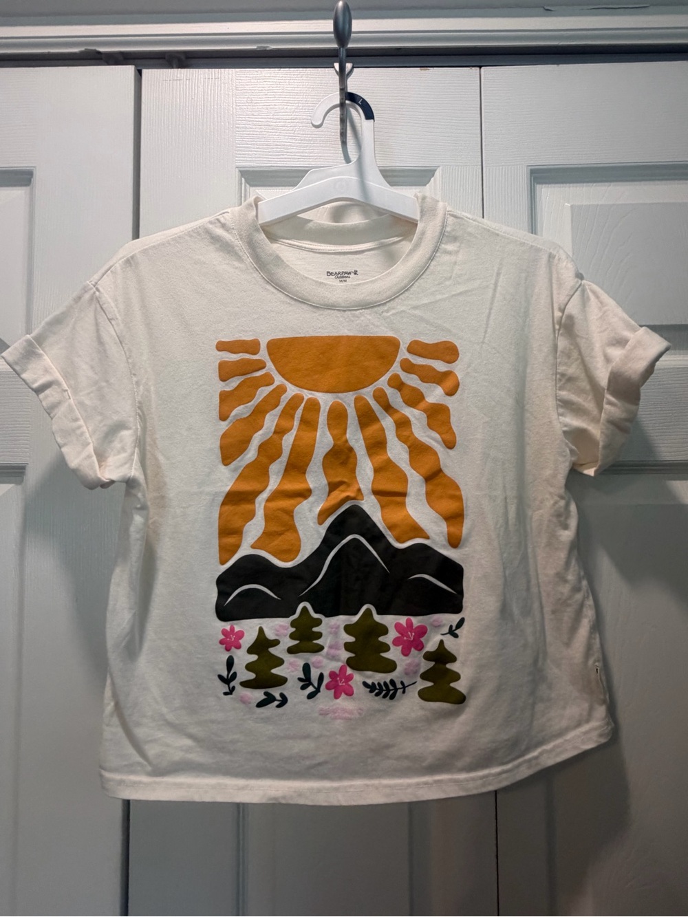 BearPaw Cream Tee with Orange Sun, Black Mountains & Pink Flowers
